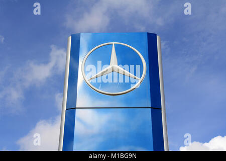 SALO, FINLAND - AUGUST 31: Mercedes-Benz sign against blue sky on August 31, 2013 in Salo, Finland. Mercedes-Benz is a multinational division of the G Stock Photo
