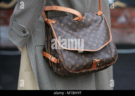 MILAN - JUNE 18: Man with Louis Vuitton brown backpack before