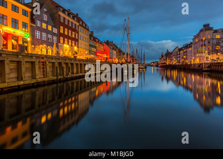 COPENHAGEN, DENMARK - FEBRUARY 28, 2017: Nyhavn at night. A 17th-century waterfront, canal and entertainment district with brightly colored townhouses Stock Photo