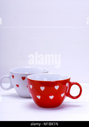 two empty ceramic mugs for coffee on a white background, empty space at the top Stock Photo
