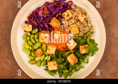 Asian Style Spicy Vegan or Vegetarian Tofu Salad Against A Red Background Stock Photo