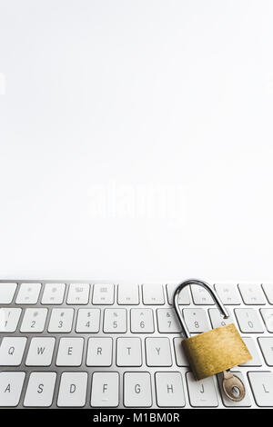 Background image of golden metal lock on keyboard Stock Photo