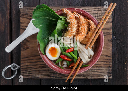 Top view af noodle soup with fried prawns, egg and pak-choi Stock Photo