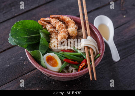 Tempura shrimps with asian noodle soup in a bowl Stock Photo