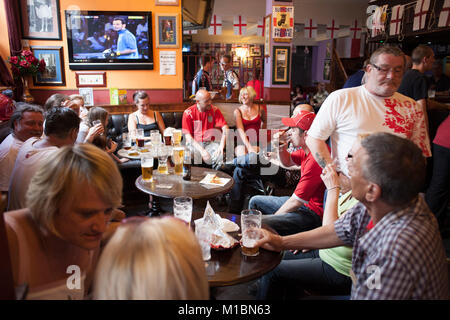 Locals at the Queens Head pub, Burlslem, Stoke-on Trent, watch the England World Cup match versus Slovenia, 23rd June 2010. Burslem was once the Mother town of the ceramic and pottery industry, but now only a few of the Pot Banks are fuctioning as most of the industry has moved to the far east. Rich Bowen Photography Stock Photo