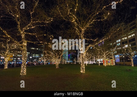 BERLIN - DECEMBER 18, 2017: Decorated for Christmas with brightly colored garlands of trees at Leipziger Platz. Stock Photo