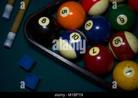 Top view of billiard balls, cue sticks, chalk on green billiard table, cinematic photo Stock Photo