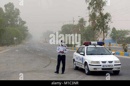 Iranian policeman in the mask at the time of sand-storm air pollution in the Ahvaz city of Iran Stock Photo