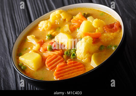 Vegetarian curry from vegetables with coconut milk close-up in a bowl on the table. horizontal Stock Photo