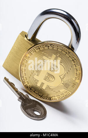 an bitcoin with a lock and a key isolated Stock Photo