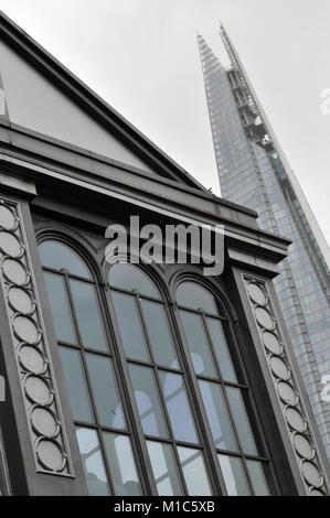 A different or unusual viewpoint or angle of the shard office building in central london.  Old and new buildings and architecture in the capital city. Stock Photo