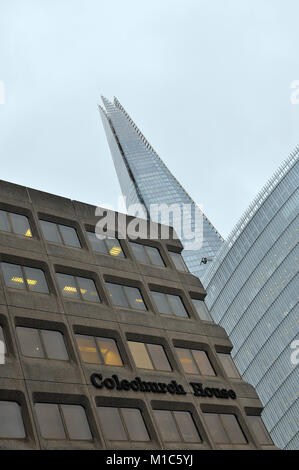 A different or unusual view of the shard office buildings in central london surrounded by older buildings and architecture. Iconic london skyline city Stock Photo