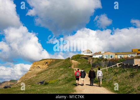 West Bay Bridport Dorset England April 23, 2016 Walkers on the South West Coast Path at West Bay. This is part of Dorset's Jurassic Coast, a World Her Stock Photo