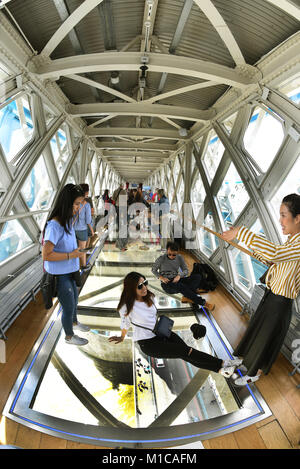 London, UK. 20th Aug, 2017. Tourists take pictures inside the tower bridge in London, England, 20 August 2017. The glass walls and floor were built in in 2014. The bridge below, with its traffic and pedestrian activity can be watched from above. - NO WIRE SERVICE - Credit: Waltraud Grubitzsch/dpa-Zentralbild/dpa/Alamy Live News Stock Photo