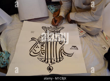 Srinagar, India. 23rd July, 2017. A Calligrapher at work at an exhibition organized by the Tourism department in Srinagar, Indian administered Kashmir. Around 50 students from different schools of Srinagar, artists from Cultural Academy and other artists had put on display their calligraphic works in Arabic, Persian and Kashmiri language. Credit: Saqib Majeed/SOPA/ZUMA Wire/Alamy Live News Stock Photo