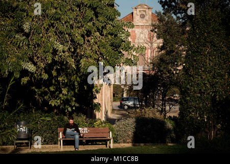 Barcelona, Catalonia, Spain. 29th Jan, 2018. In Barcelona a man reads a book at Ciutadella park with the Catalan Parliament building on the background hours prior to the Catalonia President investiture debate. The Catalan Parliament convened the debate on investing Carles Puigdemont as president of Catalonia for Tuesday 30th January. The announcement came despite threats from the Spanish government that they would challenge a potential Puigdemont candidacy to Spain's Constitutional Court. Credit: Jordi Boixareu/ZUMA Wire/Alamy Live News Stock Photo