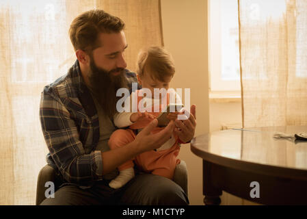 Father and son using mobile phone Stock Photo