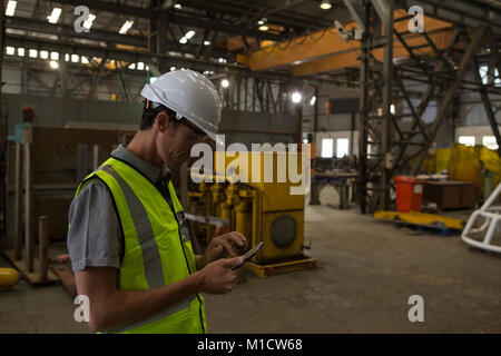 Marine engineer using mobile phone Stock Photo