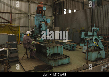Worker using pipe binder machine Stock Photo