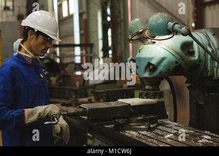 Worker using milling machine Stock Photo