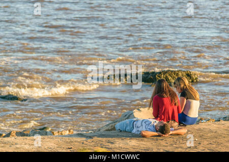 MONTEVIDEO, URUGUAY, OCTOBER - 2017 - Teens enjoying a summer day a coast of river in Montevideo city, Uruguay Stock Photo