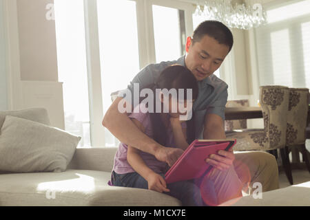 Father and daughter using digital tablet Stock Photo