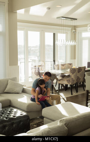 Father and daughter using digital tablet Stock Photo