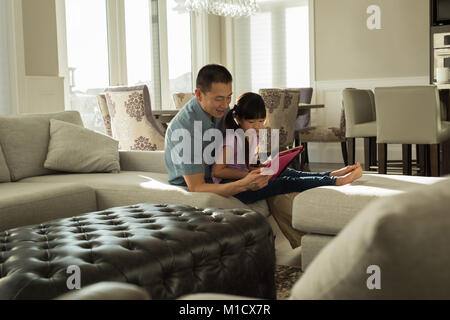 Father and daughter using digital tablet Stock Photo