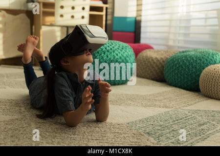 Girl using virtual reality headset in living room Stock Photo