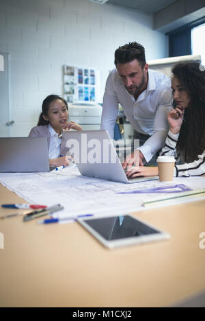 Executives working on laptop Stock Photo