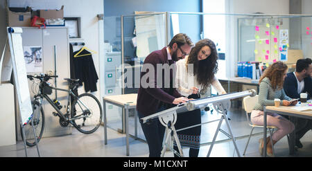 Executives working on drafting table Stock Photo