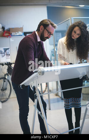 Executives working on drafting table Stock Photo