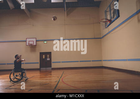 Disabled man practicing basketball in the court Stock Photo