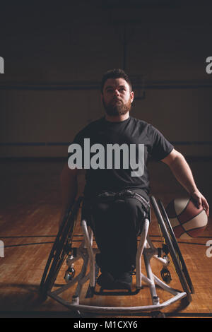 Disabled man practicing basketball in the court Stock Photo