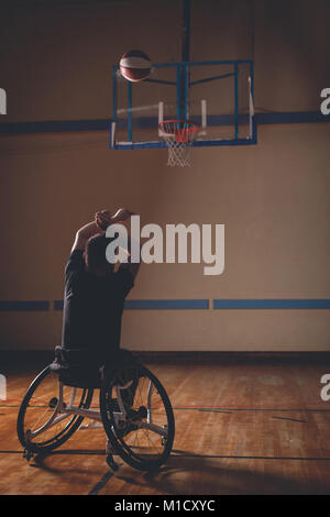 Disabled man practicing basketball in the court Stock Photo