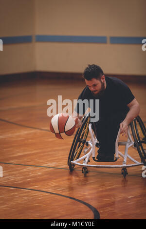 Disabled man practicing basketball in the court Stock Photo