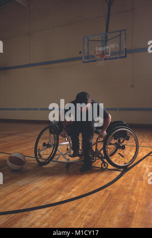 Disabled man in wheelchair at basketball court Stock Photo