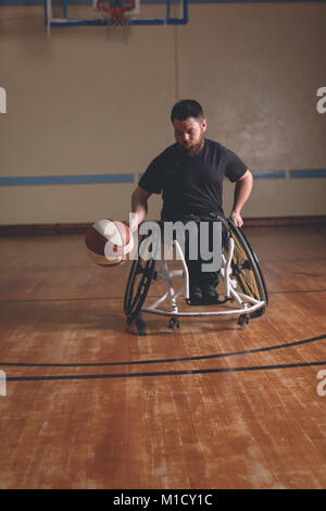 Disabled man practicing basketball in the court Stock Photo
