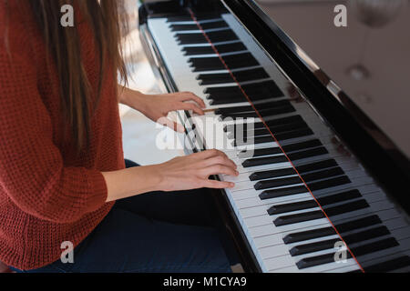 Piano music pianist hands playing. Musical instrument grand piano details with performer hand on white background Stock Photo