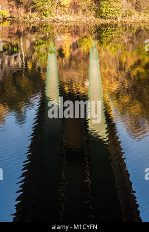 A portrait image of the underside of the Coronation Bridge of the A9 in Scotland reflected in the River Tummel, Pitlochry, Perthshire. 17 October 2009 Stock Photo