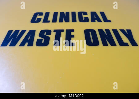 'CLINICAL WASTE ONLY' on a bin lid in a patient's hospital room. Stock Photo