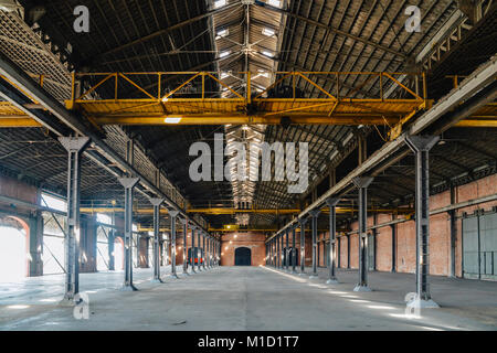 Old and dusty warehouse, with light coming through openings Stock Photo
