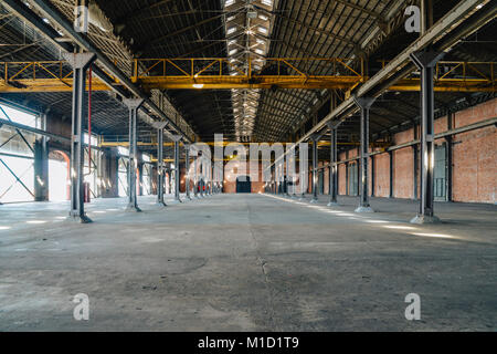Old and dusty warehouse, with light coming through openings Stock Photo