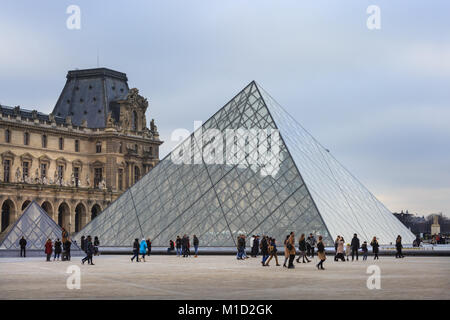 People at the glass pyramid (Pyramide du Louvre) entrance to the Louvre museum in Paris, France Stock Photo