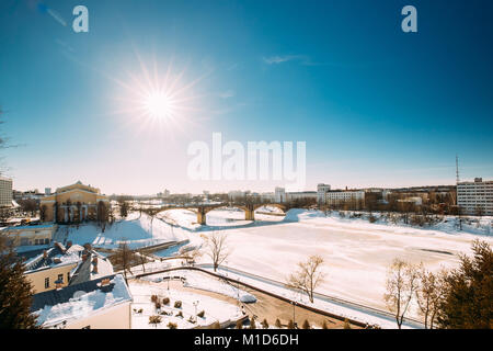 Vitebsk, Belarus. View Of National Academic Drama Theater Named After Yakub Kolas, Kirowski Bridge Across Western Dvina In Winter Sunny Sunlight Day. Stock Photo