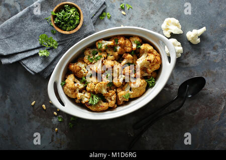 Roasted cauliflower with pine nuts and parsley Stock Photo