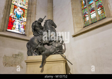 BRATISLAVA, SLOVAKIA - SEPTEMBER 25, 2017: Statue of St Martin in Hungarian hussar dress in St. Martin's Cathedral. The Saint is dividing his cloak to Stock Photo