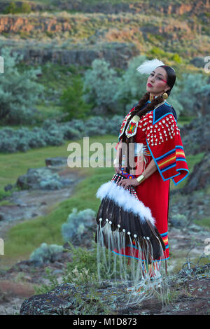 Willow Abrahamson poses along a basalt cliff at Twin Falls State Park in Idaho. model release yes. Stock Photo