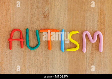 Autism. Autism spectrum disorder. Autism word made out of playdough. Wooden background. Close up. Stock Photo