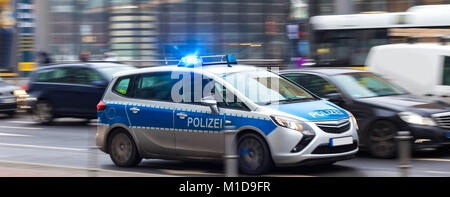 german police car speeding in city traffic Stock Photo